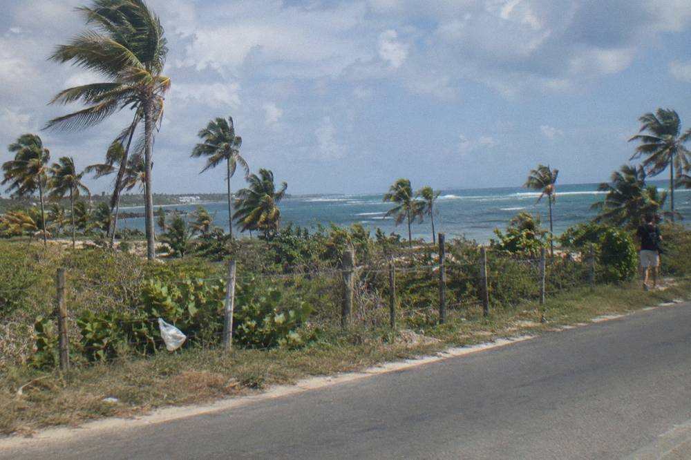 A toll highway through green tropical countryside heading toward the coast