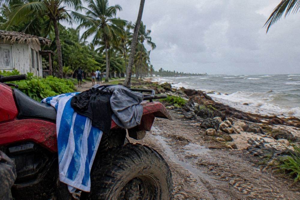 Beach towel and dry clothes draped over an ATV seat after a muddy ride