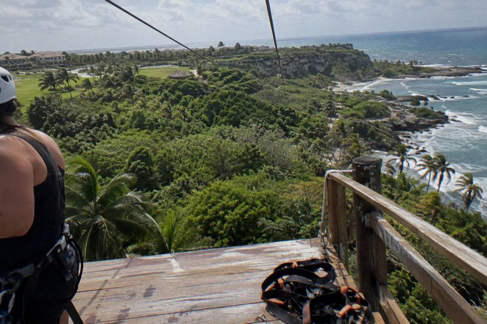 A zipline platform above a forest canopy with cables stretching between trees