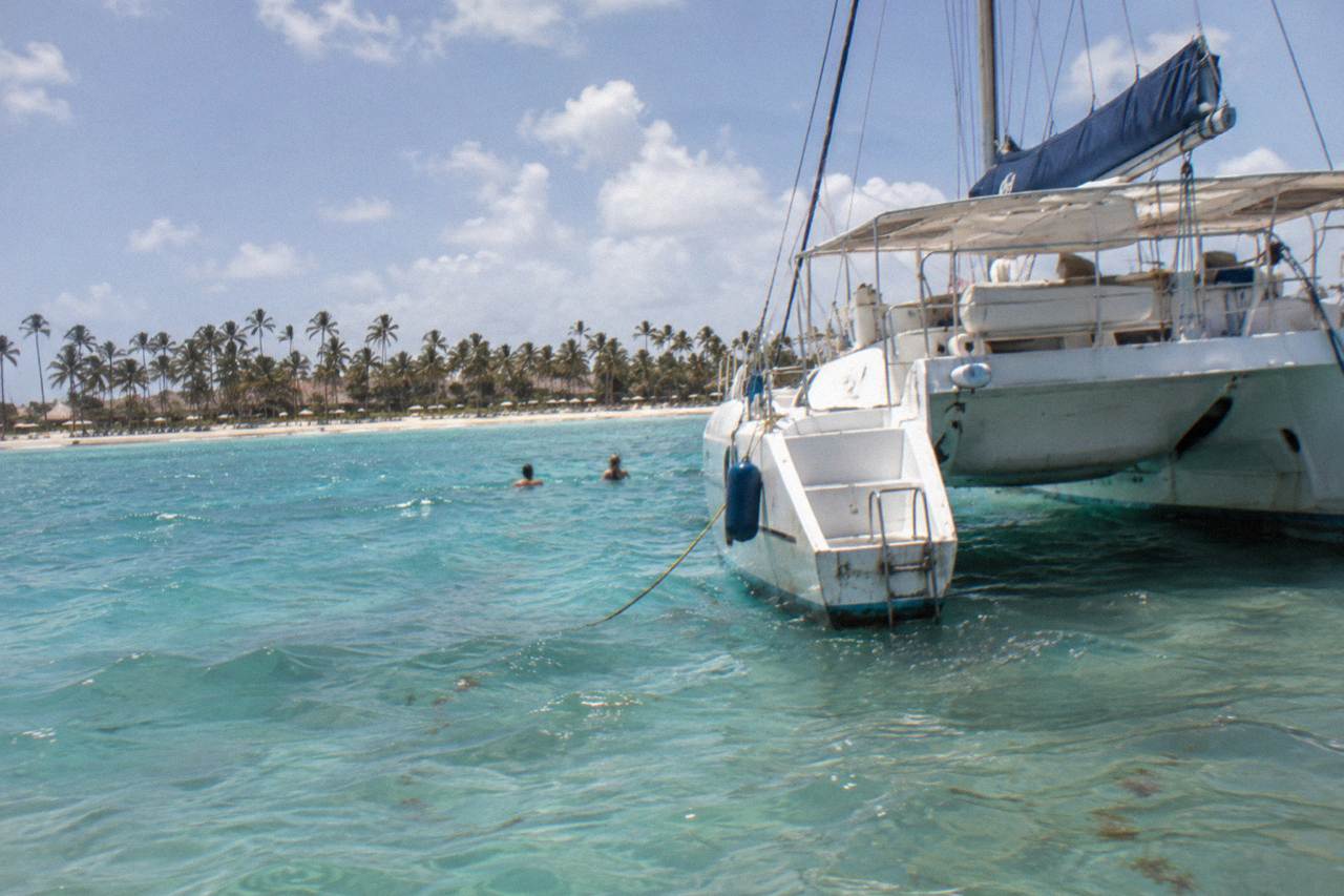 A catamaran anchored in clear turquoise water off the coast of Punta Cana