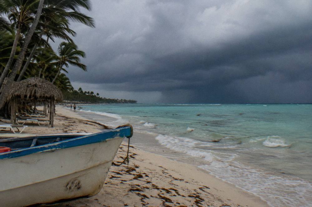 Dark storm clouds gathering over calm turquoise water along the Bavaro coast