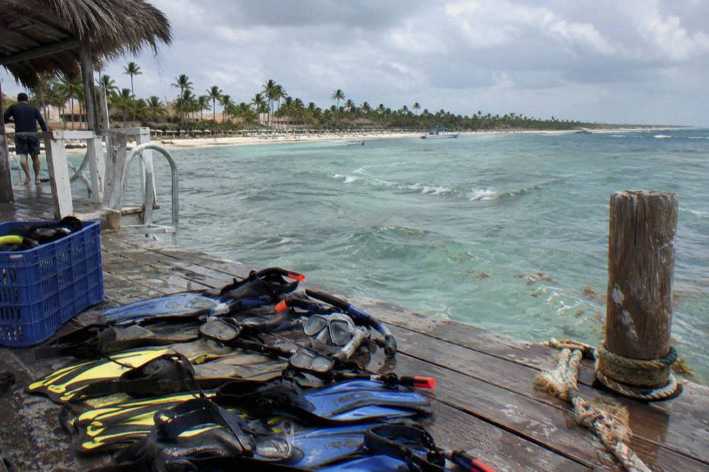 Snorkel masks and fins arranged on the deck of a boat