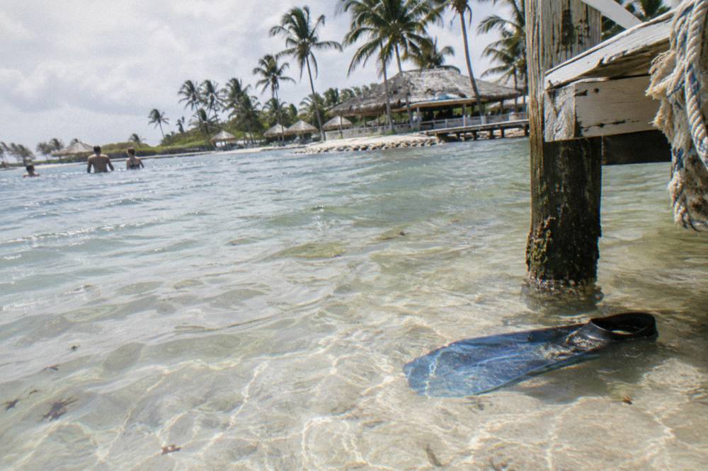 Shallow clear water over pale sand inside a lagoon enclosure